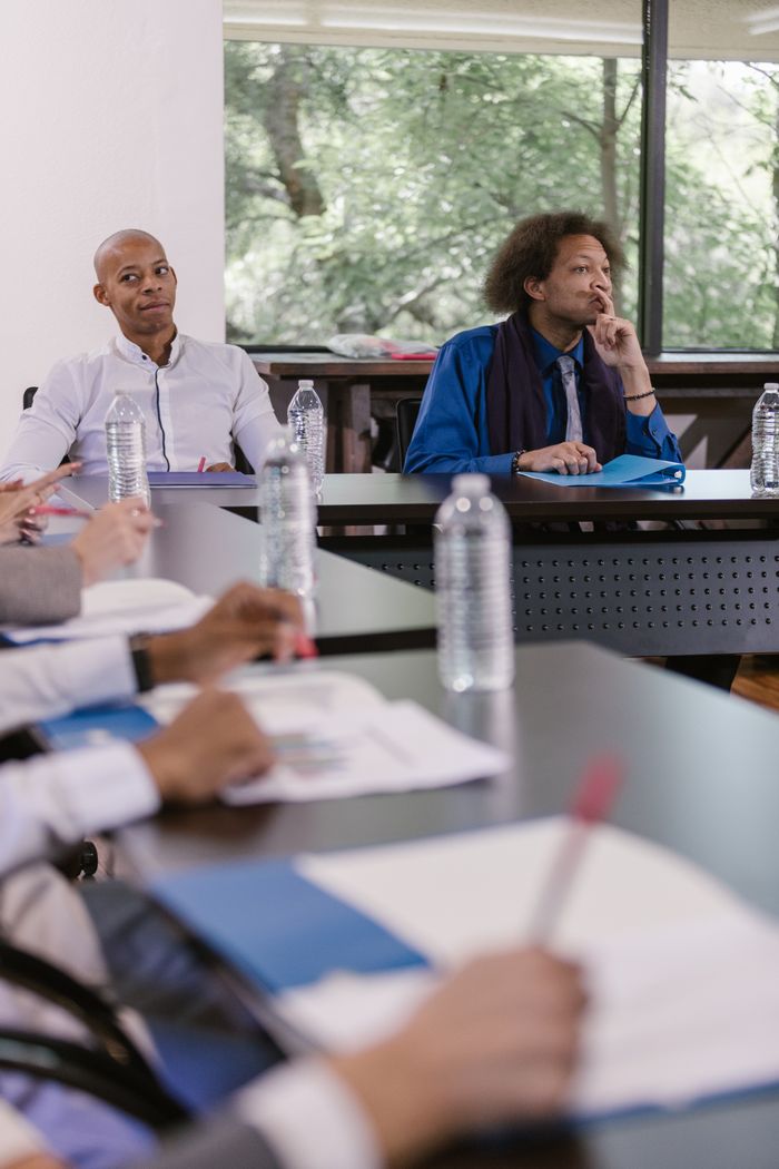 The Art of Drawing Readers In: Your attractive post title goes here A diverse group of professionals attentively participating in a formal business meeting.